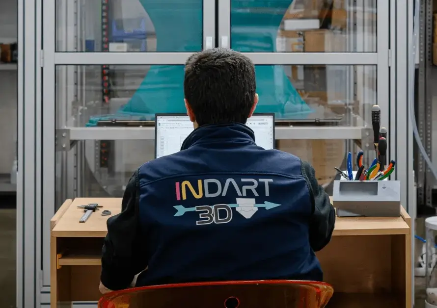 3D printing technician at work, monitoring the production process in a state-of-the-art laboratory.