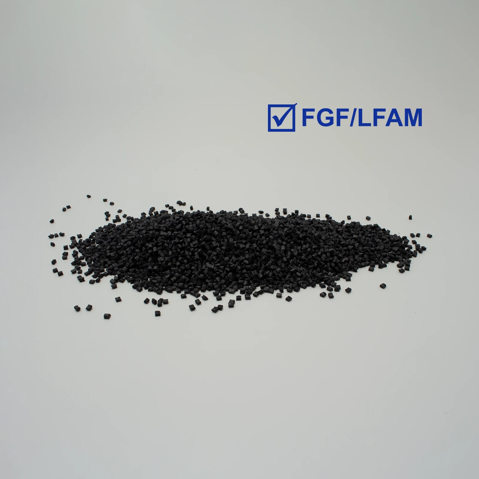 Black plastic pellets for FGF/LFAM technologies on a light gray background.
